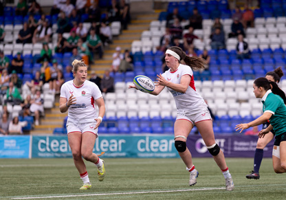 Jodie catches a ball on the rugby pitch.