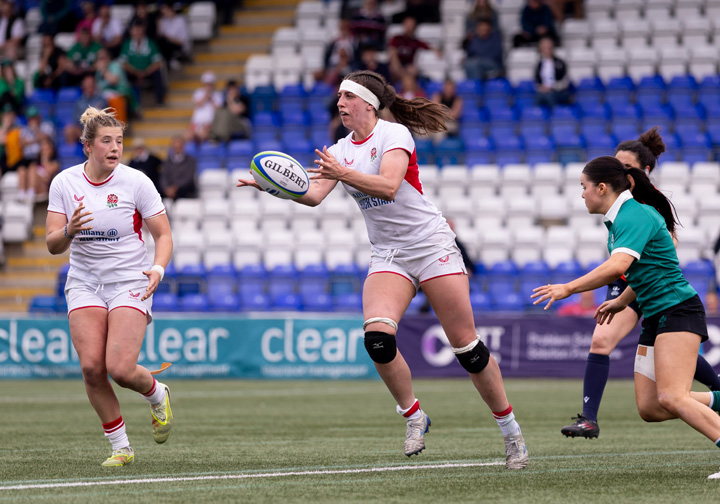 Jodie catches a ball on the rugby pitch.