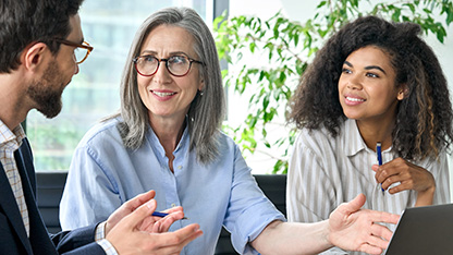 Three people in a professional team engaged in discussion