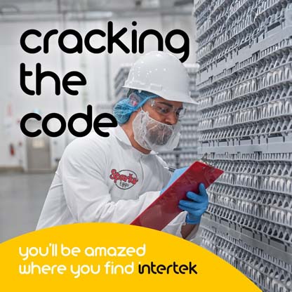 A warehouse worker wearing a lab coat and facemask checking a stack of eggs